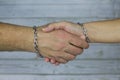 Handshake in a steel chain Royalty Free Stock Photo