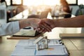 Handshake a successful real estate transaction in an office. Business people shake hands after signing a house purchase