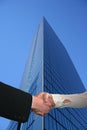Handshake with tall skyscraper