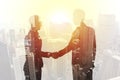 Handshake of two businessperson in office concept of partnership and teamwork.double exposure