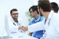 Handshake between the two doctors during the working meeting Royalty Free Stock Photo