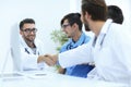 Handshake between the two doctors during the working meeting Royalty Free Stock Photo