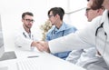 Handshake between the two doctors during the working meeting Royalty Free Stock Photo