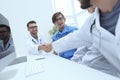 Handshake between the two doctors during the working meeting Royalty Free Stock Photo