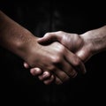 Handshake. Two white men shaking hands, dark background Royalty Free Stock Photo