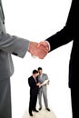 Handshake and two working businessmen