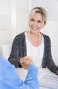 Handshake under two business woman at the office. Royalty Free Stock Photo