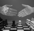 Handshake on white background with chess figures - partnership, merger and acquisition concepts. Joint venture Royalty Free Stock Photo