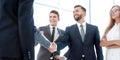 Handshake of young business partners in the office Royalty Free Stock Photo