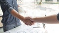 Handshaking between an architect and a contractor of agreement after collaboration