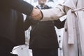 Handshaking business person in office. concept of teamwork and partnership.