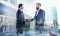 Handshaking business person in office. concept of teamwork and partnership. double exposure Royalty Free Stock Photo
