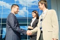 Handshaking in front of a modern building Royalty Free Stock Photo