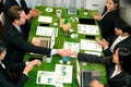 Handshaking between green business partnership over meeting table. Quaint Royalty Free Stock Photo