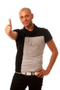 Handsom young man gesturing success with thumb up isolated over