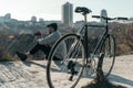 handsome adult man with vintage film camera and bicycle sitting Royalty Free Stock Photo