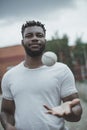 Handsome african american baseball player catching ball on court