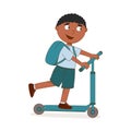 Handsome African American boy rides mechanical scooter. The foot pushes off the ground. Curly black hair, T-shirt, shorts,