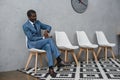 Handsome African american businessman sitting in a waiting room Royalty Free Stock Photo