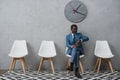 Handsome African american businessman sitting in a waiting room and looking Royalty Free Stock Photo