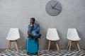 Handsome African american businessman sitting in a waiting room putting legs Royalty Free Stock Photo