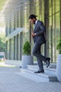 African american businessman in suit walking on stairs of office building Royalty Free Stock Photo