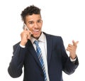 Handsome African-American businessman talking by mobile phone on white background Royalty Free Stock Photo