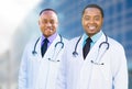 Two African American Male Doctors Outside of Hospital Building