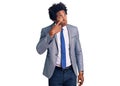 Handsome african american man with afro hair wearing business jacket pointing to the eye watching you gesture, suspicious Royalty Free Stock Photo