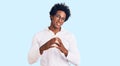 Handsome african american man with afro hair wearing casual clothes and glasses hands together and fingers crossed smiling relaxed Royalty Free Stock Photo