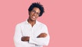 Handsome african american man with afro hair wearing casual clothes and glasses happy face smiling with crossed arms looking at Royalty Free Stock Photo