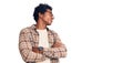 Handsome african american man with afro hair wearing casual clothes and glasses looking to the side with arms crossed convinced Royalty Free Stock Photo