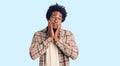 Handsome african american man with afro hair wearing casual clothes and glasses tired hands covering face, depression and sadness,