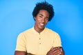 Handsome african american man with afro hair wearing casual clothes happy face smiling with crossed arms looking at the camera Royalty Free Stock Photo