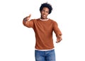 Handsome african american man with afro hair wearing casual clothes looking at the camera smiling with open arms for hug Royalty Free Stock Photo