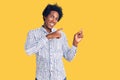 Handsome african american man with afro hair wearing casual clothes smiling and looking at the camera pointing with two hands and Royalty Free Stock Photo