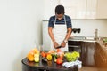 African man preparing healthy food at home in kitchen Royalty Free Stock Photo