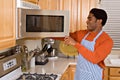 Handsome African-American man cooks in kitchen Royalty Free Stock Photo