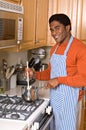 Handsome African-American man cooks in kitchen Royalty Free Stock Photo