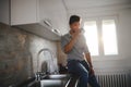 Handsome african american man drinking coffee in kitchen Royalty Free Stock Photo