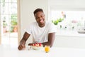 Handsome african american man eating heatlhy cereals and berries as breakfast