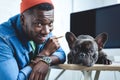 Handsome african american man with Frenchie dog