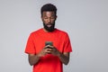 Handsome African American man holding mobile phone isolated on white background Royalty Free Stock Photo