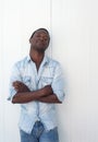 Handsome african american man leaning against white wall outdoors Royalty Free Stock Photo