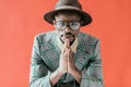 handsome african american man posing in vintage eyeglasses and hat, Royalty Free Stock Photo