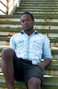 Handsome african american man sitting on stairs outdoors Royalty Free Stock Photo