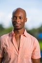 Handsome African American man smiling off camera. Photo man taken outside with blurry background Royalty Free Stock Photo