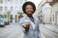 Handsome african man posing on street with cup of coffee Royalty Free Stock Photo