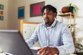 African American smiling freelancer working remotely from home