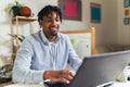 African American smiling freelancer working remotely from home